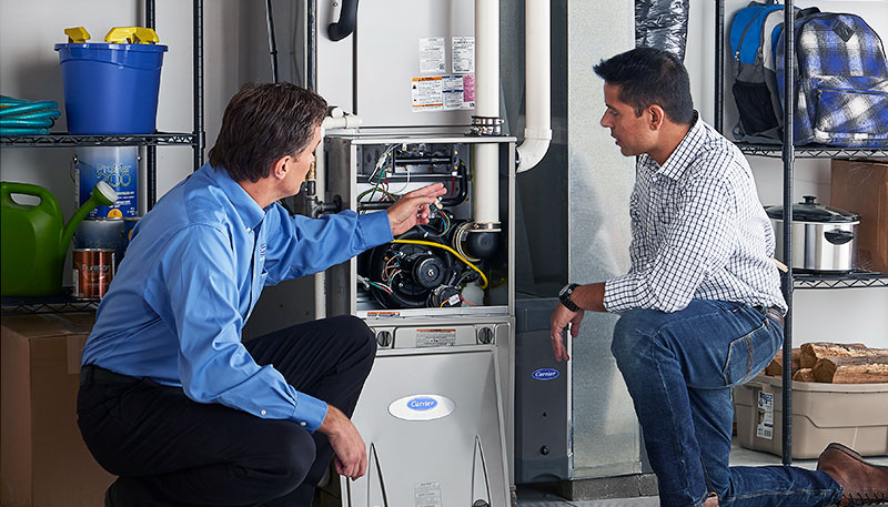 HVAC technician evaluating a furnace for repair or replacement in Goodyear