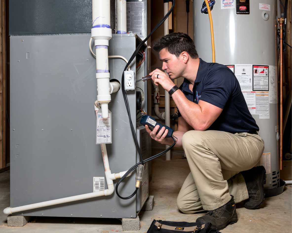 HVAC technician performing a furnace tune-up in Goodyear