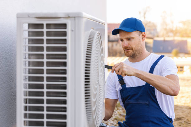 HVAC technician servicing an outdoor air conditioning unit in Goodyear