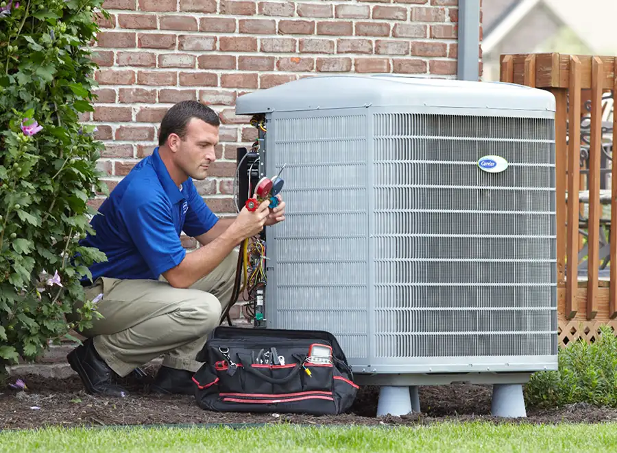 HVAC technician inspecting an outdoor air conditioning unit in Goodyear