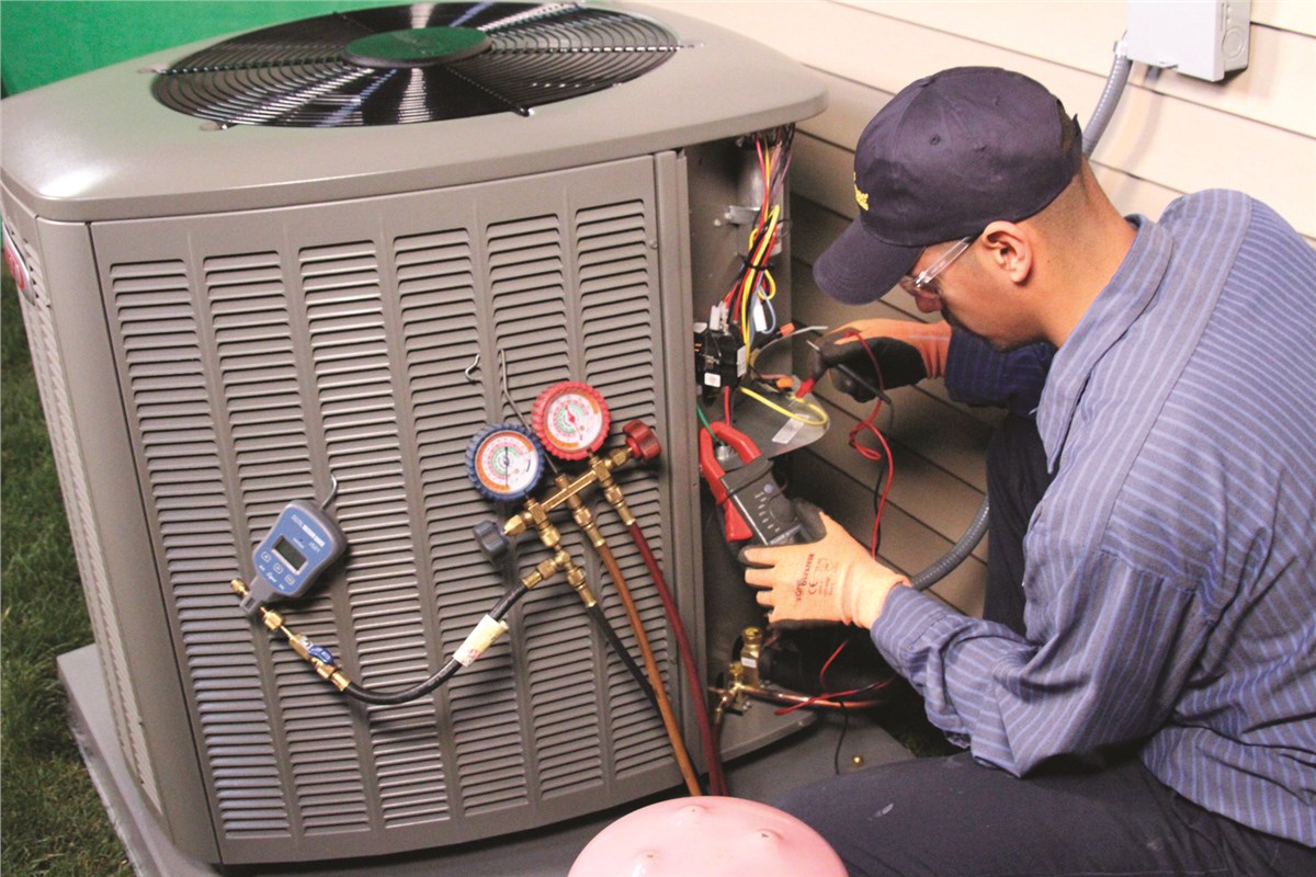 HVAC technician testing an outdoor air conditioning unit in Goodyear